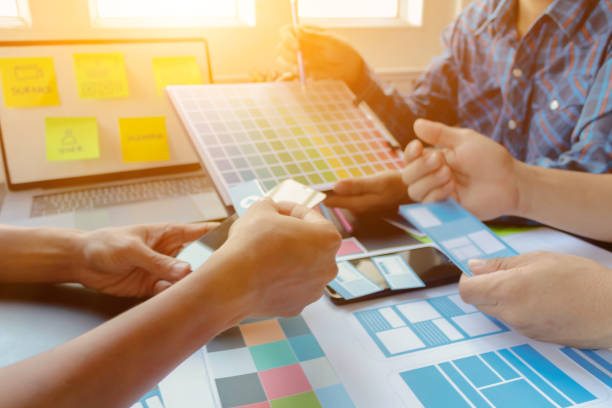 istock Smooth Focus, group of web designers are working together to develop mobile responsive website with UI UX Front End Designer Previewing. website designers in form of mobile applications with UI UX 2166074367
