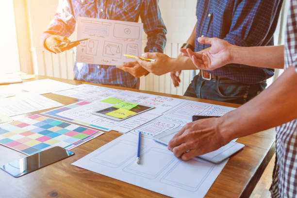 istock Smooth Focus, group of web designers are working together to develop mobile responsive website with UI UX Front End Designer Previewing. website designers in form of mobile applications with UI UX 2166074416