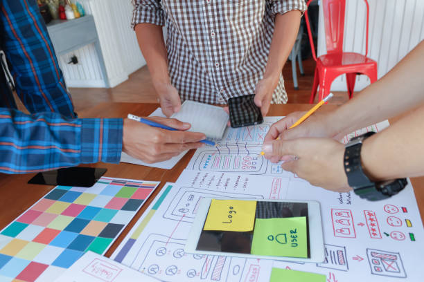istock Smooth Focus, group of web designers are working together to develop mobile responsive website with UI UX Front End Designer Previewing. website designers in form of mobile applications with UI UX 2166074536