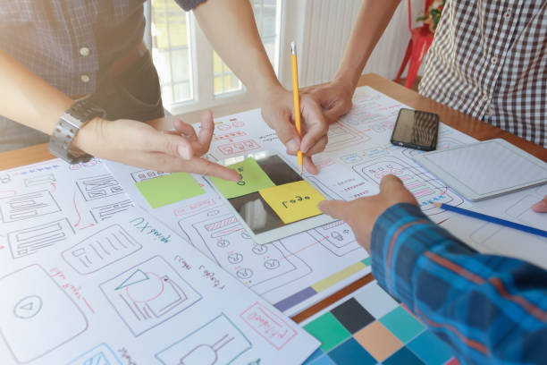 istock Smooth Focus, group of web designers are working together to develop mobile responsive website with UI UX Front End Designer Previewing. website designers in form of mobile applications with UI UX 2166074633