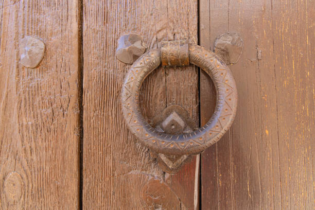Albaicin, Granada, Province of Granada, Andalusia, Spain. Old iron knocker on a painted wooden door.