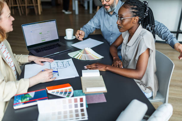 istock Interior designer meeting with clients and discussing new flat project 2166083394