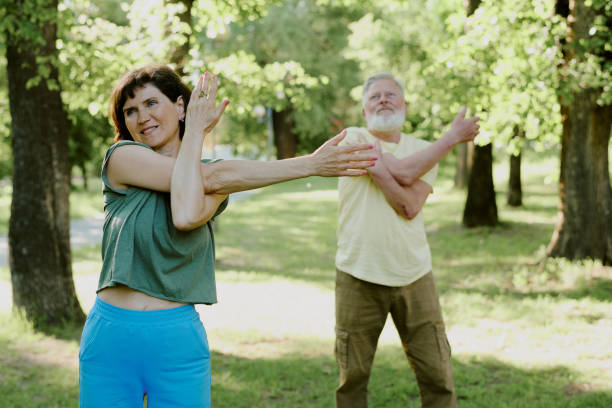 istock Partners Doing Sport in Park 2166083598