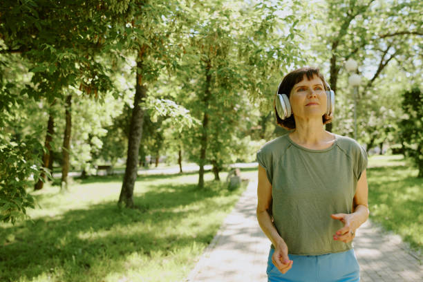 istock Brunette Woman Running in Park 2166083940