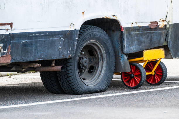 Close up of a bus wheel with a shiny metallic hubcap and black tire, highlighting the vehicle's maintenance and design