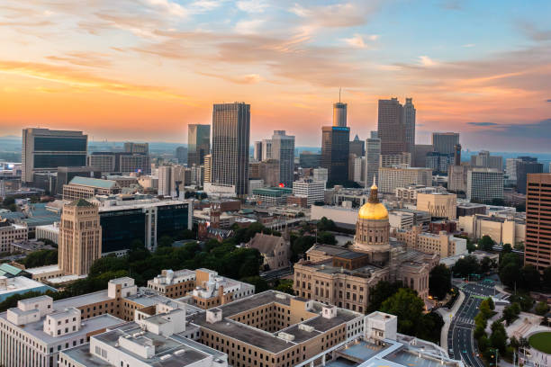 Atlanta Georgia State Capitol and city skyline aerial establishing shot Aerial video over the Atlanta, Georgia state capitol with the skyline atlanta skyline stock pictures, royalty-free photos & images