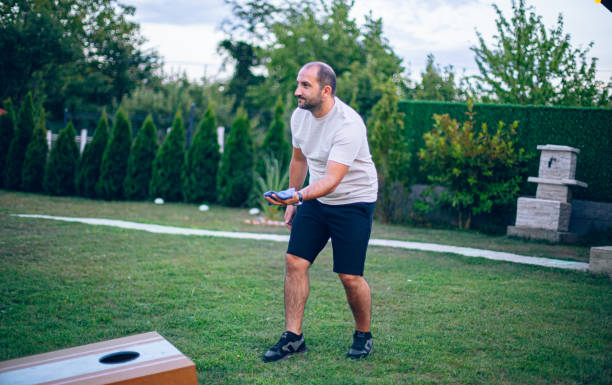 istock Playing bean bag toss in the backyard 2166086143