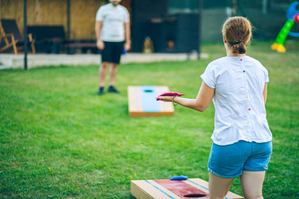 istock Couple playing bean bag toss in the backyard 2166086243
