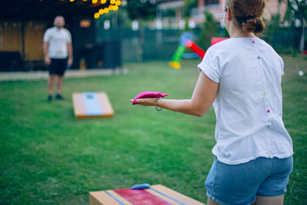 istock Couple playing bean bag toss in the backyard 2166086314