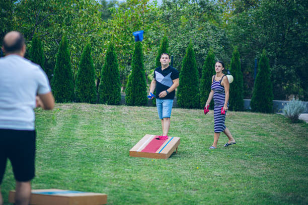 istock Best friends playing bean bag toss in the backyard 2166086383