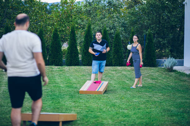 istock Best friends playing bean bag toss in the backyard 2166086459