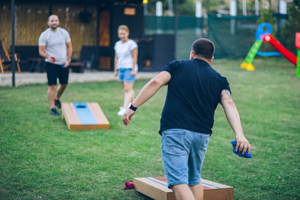 istock Best friends playing bean bag toss in the backyard 2166087029