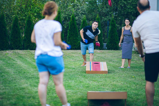 istock Best friends playing bean bag toss in the backyard 2166087073