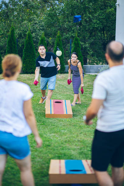 istock Best friends playing bean bag toss in the backyard 2166087232