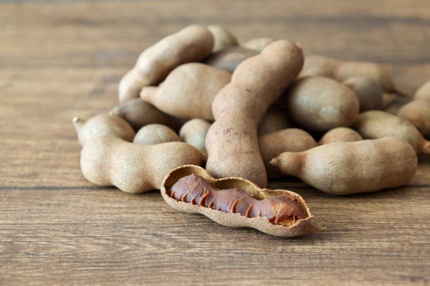 istock Tamarinds isolated on a wooden background. 2166090128