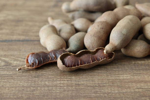 istock Tamarinds isolated on a wooden background. 2166090143