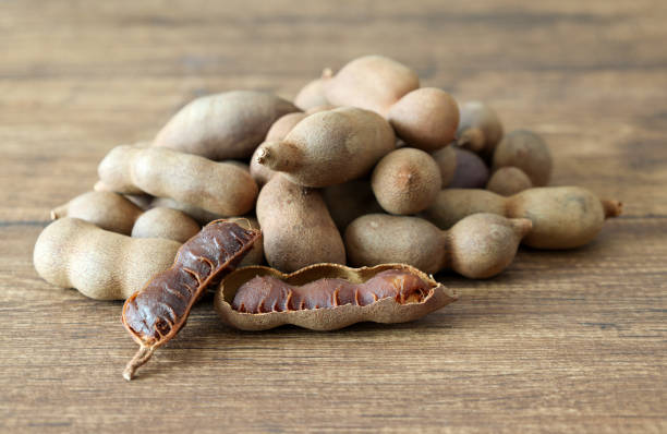 istock Tamarinds isolated on a wooden background. 2166090164