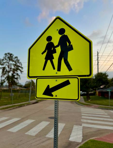 istock Yellow people crossing sign at crosswalk intersection 2166091271