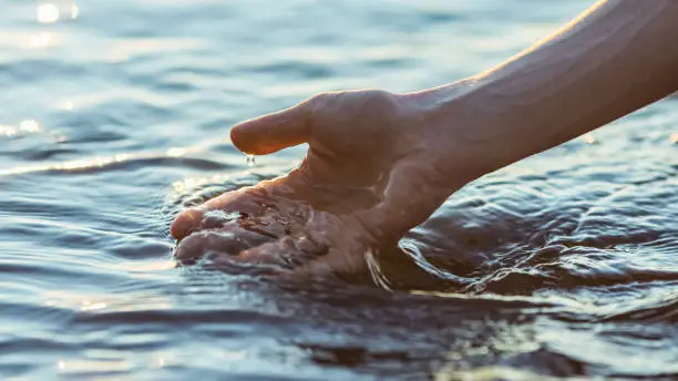 Hand touching water. Hand touching water.