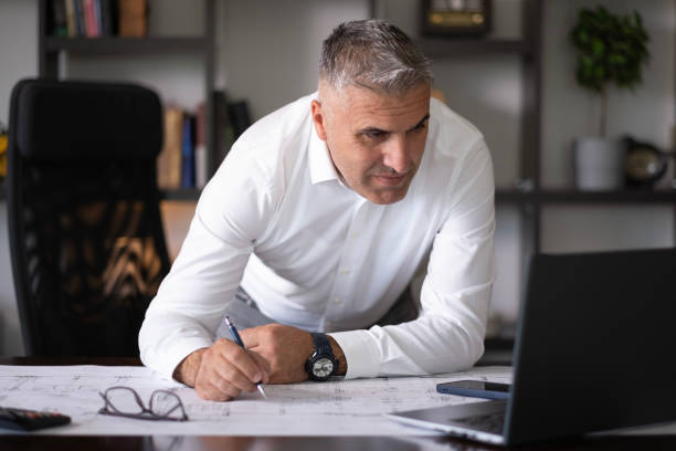 istock White-haired businessman working hard on an important project 2166094244