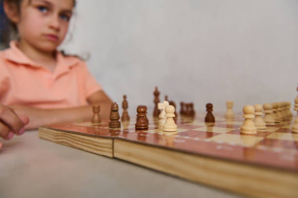 istock Focused young girl playing chess, concentration and strategy in action 2166094929