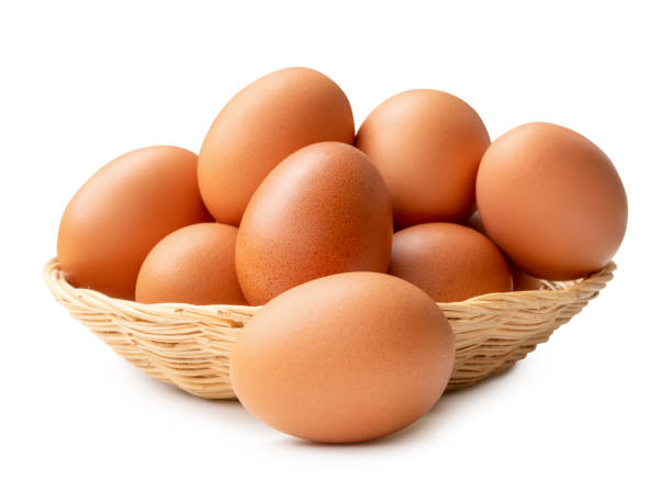 istock Front view of fresh brown chicken eggs in stack in wicker basket isolated on white background with clipping path 2166099179