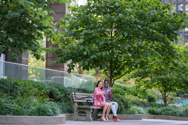 istock Young women take selfie on park bench 2166099184