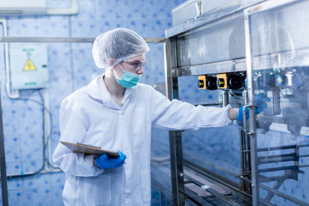 istock Female worker checking quality drinking water before process of filling water into plastic bottles to bring out to consumers. Water bottles on production line of factory. 2166111586