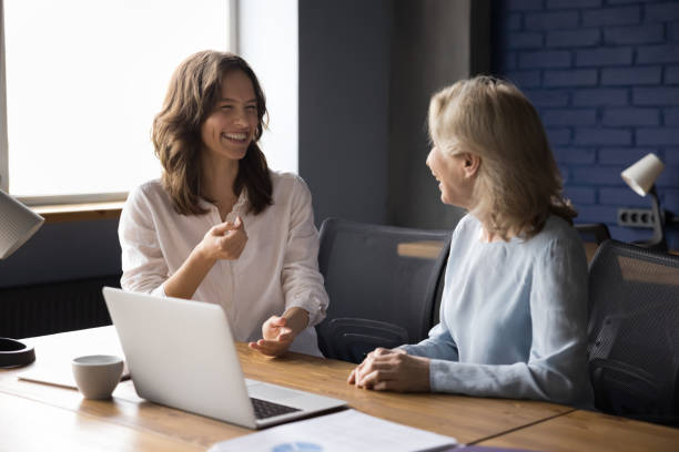 istock Two laughing colleagues enjoy pleasant conversation in office 2166114977