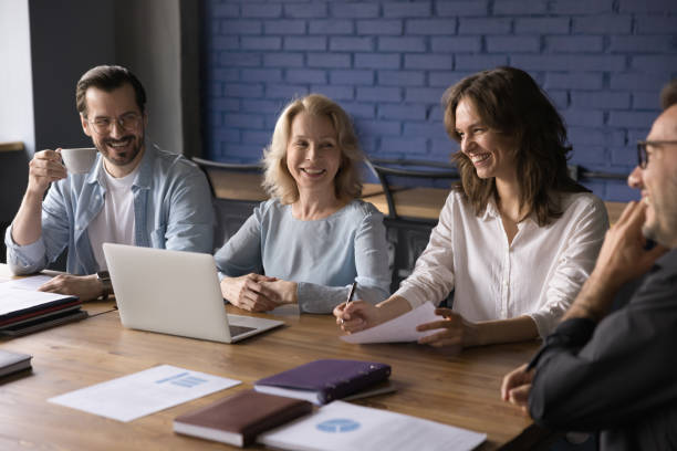 istock Smiling team laughing work together at corporate briefing 2166115100