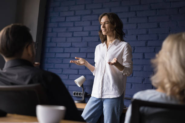 istock Young woman employee shares creative solution in group briefing 2166115801