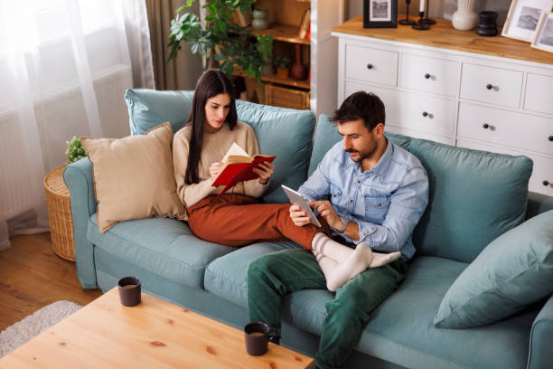 istock Couple reading and drinking coffee at home 2166118342