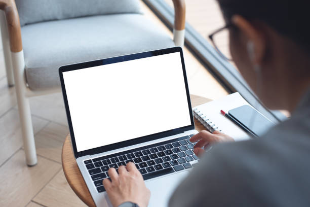 istock Mockup blank white screen laptop computer. Woman working, using laptop computer on wooden table with empty screen for advertising, template for web deign or social media marketing, freelance work 2166124541