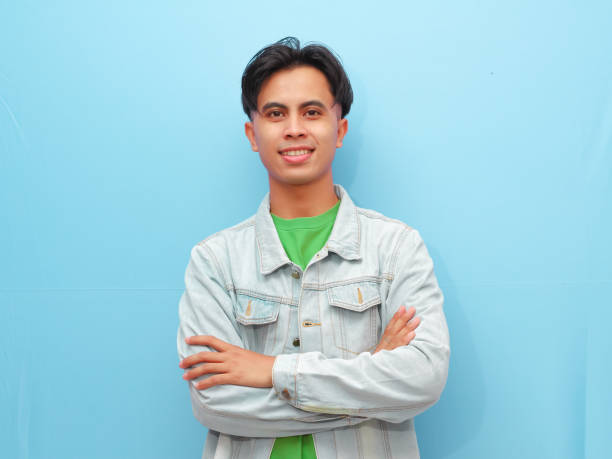 istock Handsome asian man posing crossing arms with smiling confident gesture,looking at camera isolated blue background 2166124987