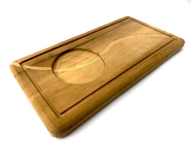 istock wooden tray with carved design on white background. 2166128293