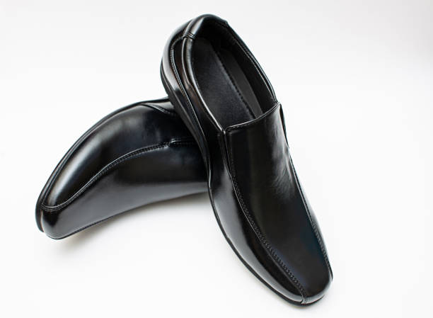 istock Black man's slippery glitter leather shoes isolated on white background. 2166132267