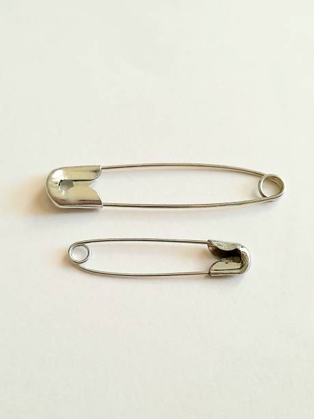 istock Two metal safety pins with white background. 2166133289