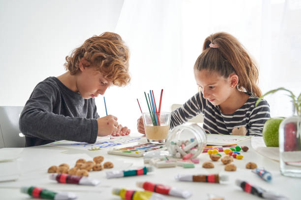 istock Focused children painting at table 2166135715