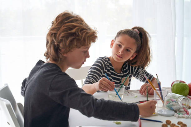 istock Cute children painting at table 2166135804