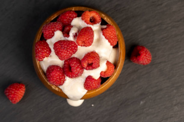 istock delicious and fresh yogurt with raspberry flavor and whole red raspberries 2166136395