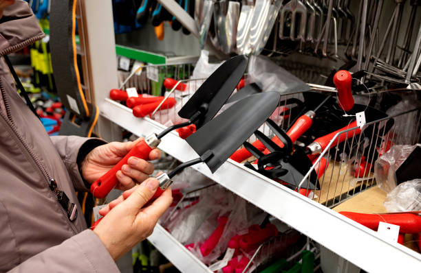 istock Person examining gardening tools in a hardware store. 2166136865