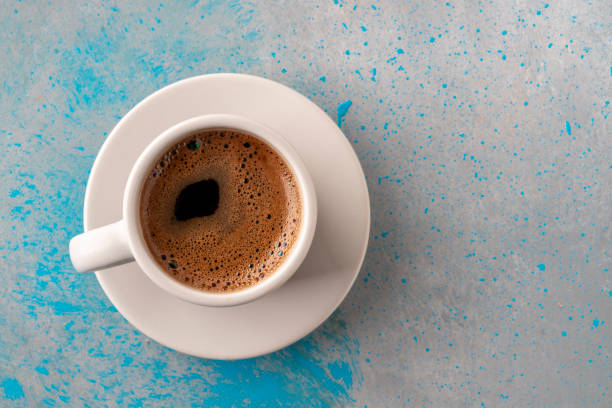 istock top view cup of coffee on gray blue table with copy space 2166136883