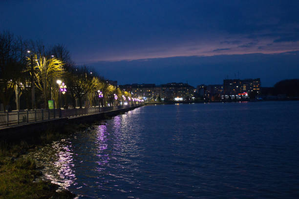 istock Evening Promenade by the Lake with Illuminated Trees 2166137509