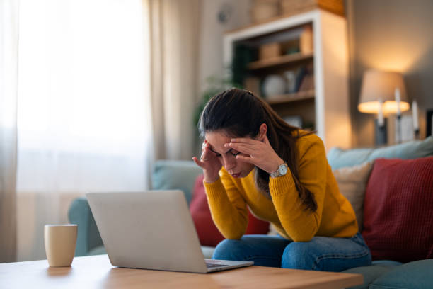 istock Concerned Woman Working on Laptop at Home 2166138977