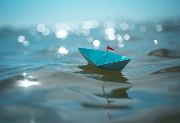 istock Blue paper boat in big waves 2166141720