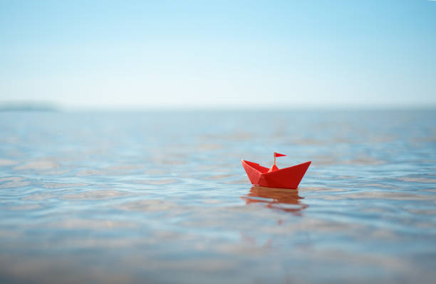 istock red paper boat by the sea 2166141733