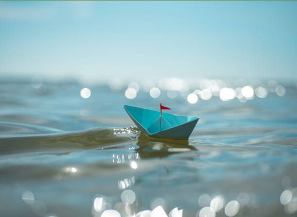 istock Blue paper boat in big waves 2166141768