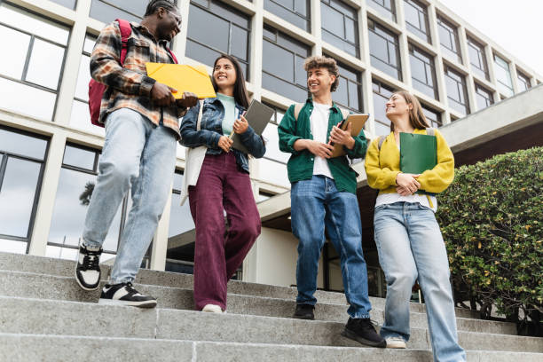 istock College Students Walking University staircase talking and laughing after lectures and exams 2166141788
