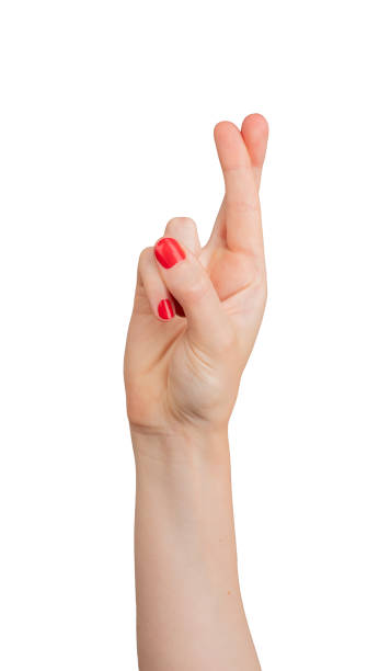 istock Finger crossed for luck, symbolizing hope and superstition. Isolated on white background, showing a 2166142549