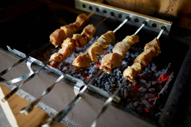 istock Summer Barbecue at Home Featuring Kebabs Grilling in a Backyard Grill 2166142633